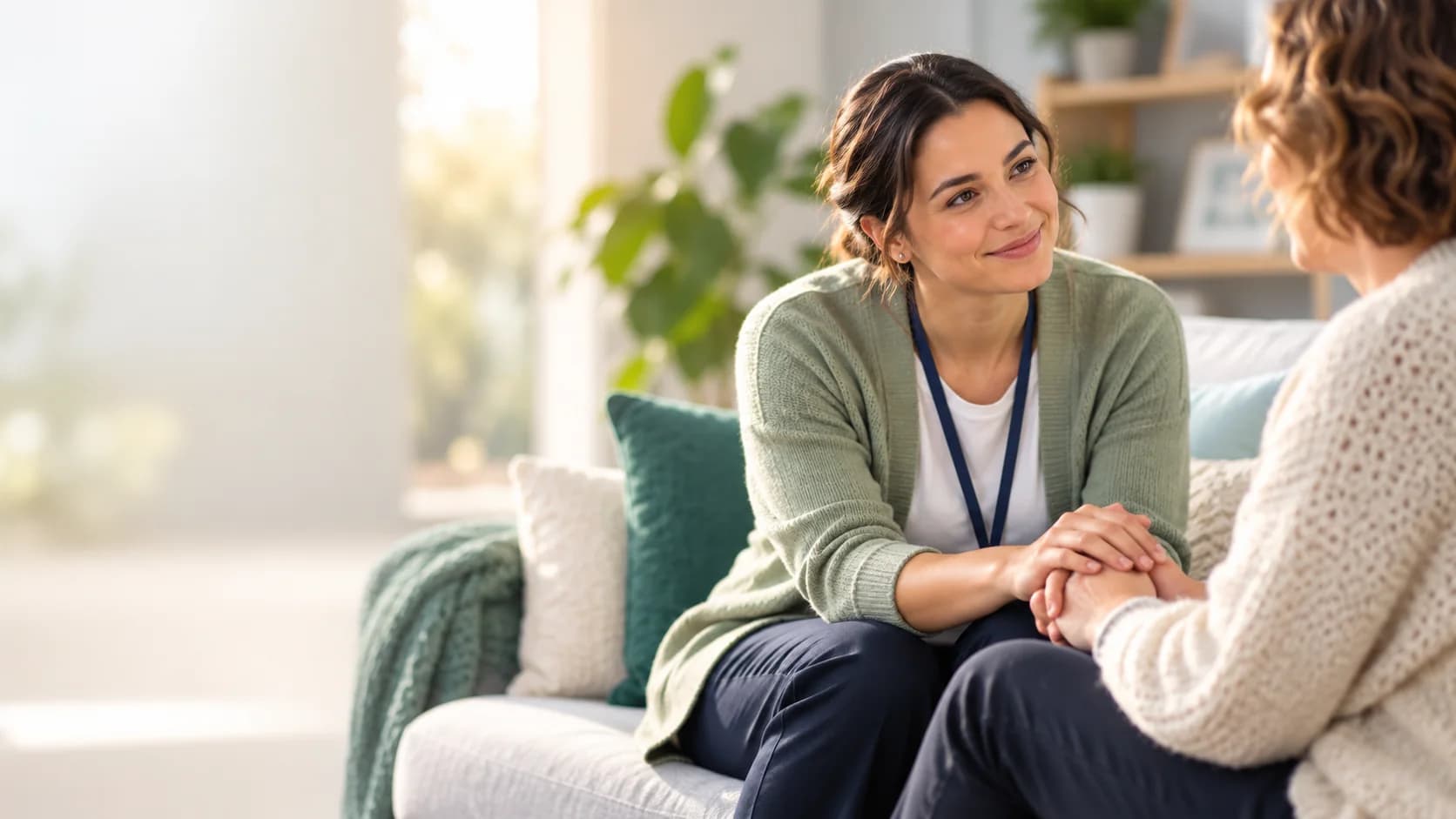 Support coordinator listening to a client in a bright, welcoming lounge